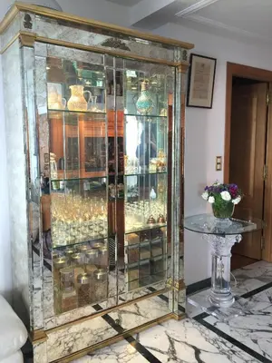 a glass display cabinet with a table in a room at Sunny Panoramic Balcony in Èze