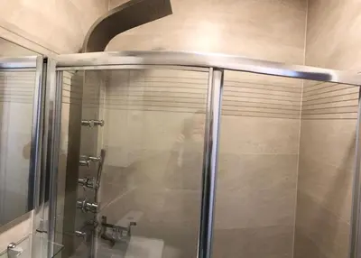 a shower with a glass door in a bathroom at Le Paradis Blue in Nice