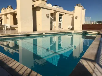 a swimming pool in front of a house at Le Paradis Blue in Nice