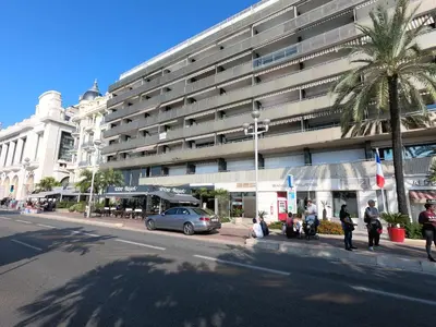 a large building with a car parked in front of it at Le Paradis Blue in Nice