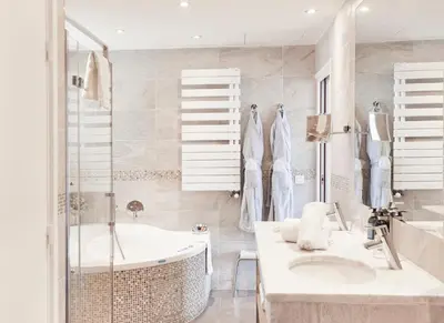 a white bathroom with a tub and a sink at Welcome Hotel in Villefranche-sur-Mer