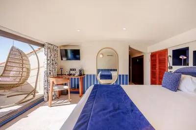 a hotel room with a large bed and a desk at Welcome Hotel in Villefranche-sur-Mer