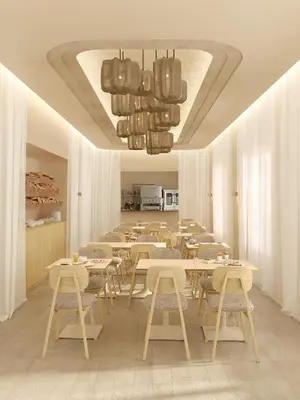 a restaurant with tables and chairs and a chandelier at Hotel Gounod Fully Renovated in Nice