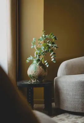 a vase sitting on a table with a plant in it at Hotel Gounod Fully Renovated in Nice
