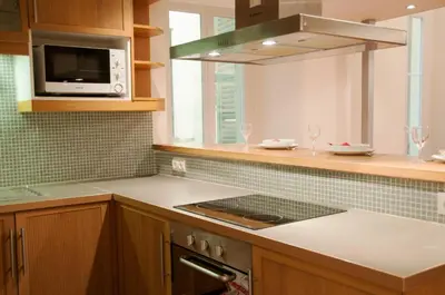 a kitchen with a stove and a microwave at Apartment Massena - Old Town in Nice