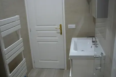 a white bathroom with a sink and a door at 2 Bedrooms Appartement In Central Location on the famous Place Massena Nice in Nice