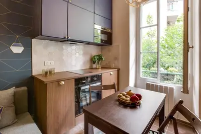 a living room with a couch and a kitchen at CASA NISSARTE - Central near Train station - PARKING - confort & cosy- AC in Nice