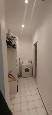 a white bathroom with a toilet in a room at Studio dans la Villa 