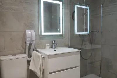 a bathroom with a sink and a shower at Hotel Busby in Nice