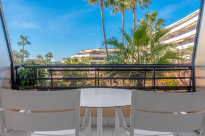 a couch and two stools on a beach at Holiday Inn Nice - Port St Laurent by IHG in Saint-Laurent-du-Var