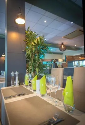 a table with wine glasses and napkins on it at Promotel in Carros