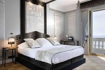 a bedroom with a large bed in a room at Hotel Le Negresco in Nice