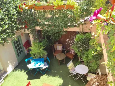 an overhead view of a garden with chairs and tables at Hotel des Dames in Nice