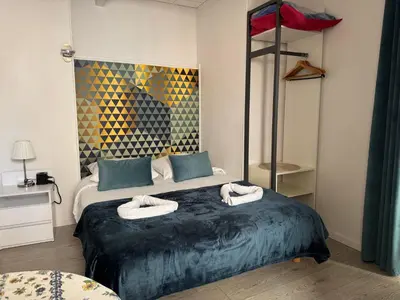 a bedroom with a bed with two towels on it at Hotel des Dames in Nice