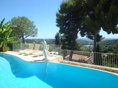 a swimming pool with a statue in the middle at La Bergerie B&B in Vence