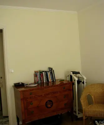 a room with a wooden dresser with books on it at Appartamento Sole in Nice