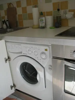 a white washing machine sitting in a kitchen at Appartamento Sole in Nice