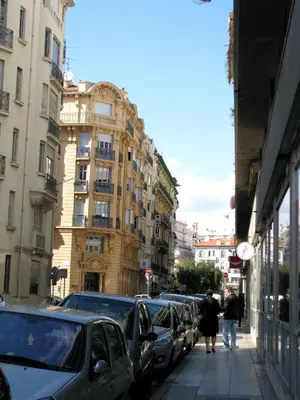 a city street with cars parked on the sidewalk at Appartamento Sole in Nice
