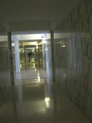 an empty hallway in a building with a long corridor at Appartamento Sole in Nice
