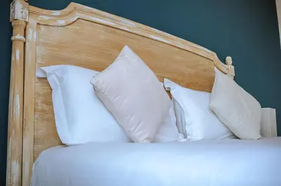 a bedroom with a bed with white pillows at Hôtel du Bord de Mer 