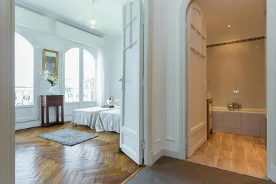 a bedroom with a bed and a tub in a room at Beautiful apartment by the sea front in Nice