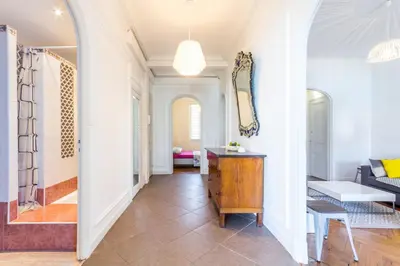 a hallway of a home with a table and a room at Beautiful apartment by the sea front in Nice