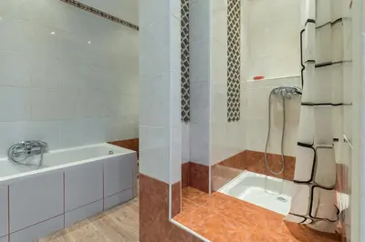 a bathroom with a shower and a bath tub at Beautiful apartment by the sea front in Nice