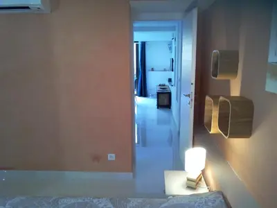 a room with a hallway with a bed and a lamp at Villa du Chateau in Nice