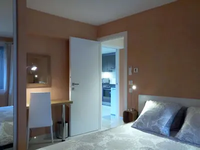 a bedroom with a bed and a desk and a table at Villa du Chateau in Nice