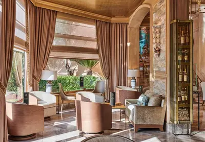 a lobby of a hotel with chairs and tables at La Réserve de Beaulieu in Beaulieu-sur-Mer