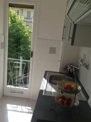 a kitchen with a sink and a bowl of fruit on a counter at Studio équipé à 9mn à pied du centre ville et de la plage in Nice
