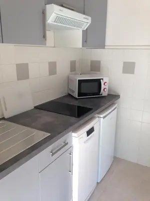a kitchen with a microwave on a counter at Studio équipé à 9mn à pied du centre ville et de la plage in Nice