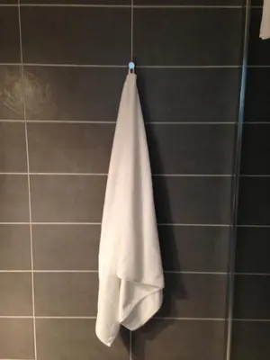 a towel hanging on a wall in a bathroom at Studio équipé à 9mn à pied du centre ville et de la plage in Nice