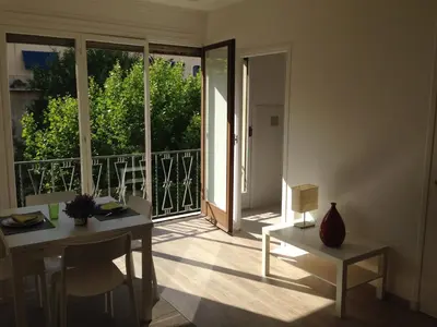 a room with a table and a view of a balcony at Studio équipé à 9mn à pied du centre ville et de la plage in Nice