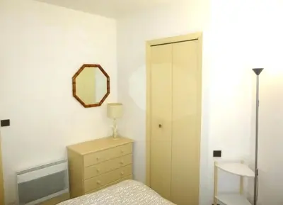 a bedroom with a bed and a mirror and a dresser at Nice-Miramar Apartment and Parking in Nice