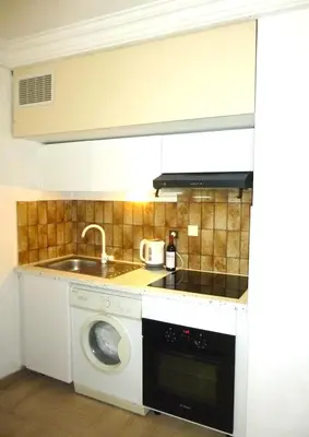 a kitchen with a sink and a washing machine at Nice-Miramar Apartment and Parking in Nice