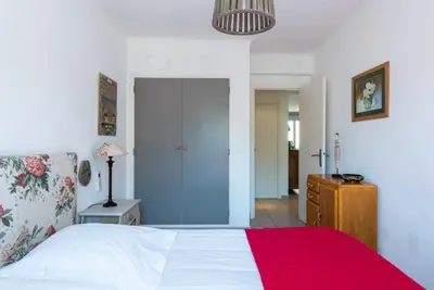 a bedroom with a white bed and a red blanket at Le Lympia in Nice