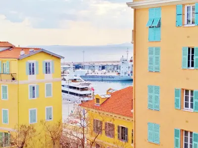 a view of a harbor between two buildings at Le Lympia in Nice