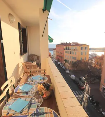 a balcony with tables and a view of a street at Le Lympia in Nice