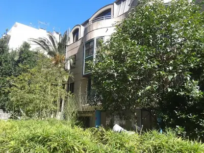 a building with a tree in front of it at Oranger in Nice