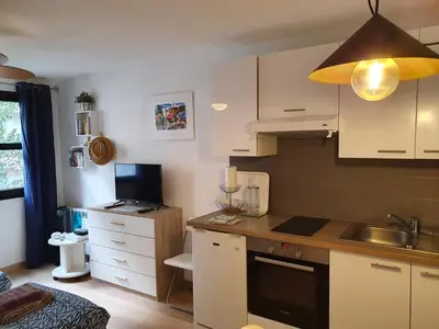 a kitchen with white cabinets and a counter top at Oranger in Nice