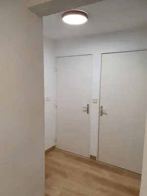 an empty room with white walls and a door at Oranger in Nice