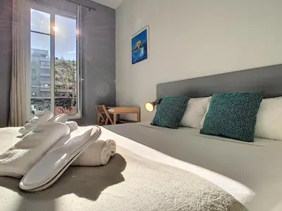 a bedroom with a large bed with surfboards on it at Nestor&Jeeves - PALAIS MARIE PRESTIGE - Central - Close sea in Nice