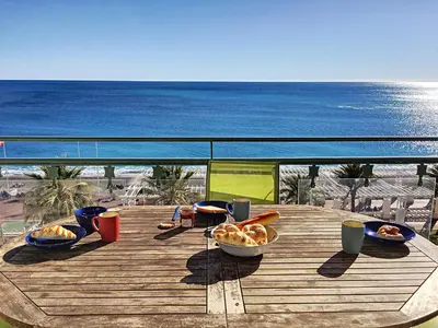 a table with a bowl of food on a balcony with the ocean at Nestor&Jeeves - PALAIS DE FRANCE - Central - Sea front in Nice