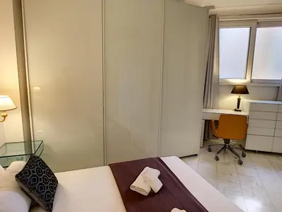 a bedroom with a bed and a desk and a chair at Nestor&Jeeves - PALAIS DE FRANCE - Central - Sea front in Nice