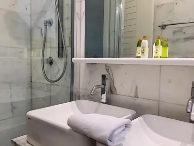 a white bathroom with a shower and a sink at Nestor&Jeeves - PALAIS DE FRANCE - Central - Sea front in Nice