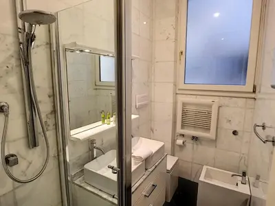 a white bathroom with a shower and a sink at Nestor&Jeeves - PALAIS DE FRANCE - Central - Sea front in Nice