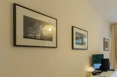 a room with three framed pictures on the wall at CENTRE PROMENADE Golden Square Terrace 1 min Walk to the Beach AC in Nice