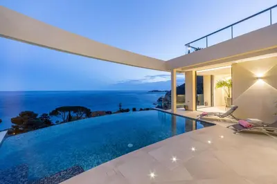 a house with a swimming pool with a view of the ocean at Villa Paradise in Èze