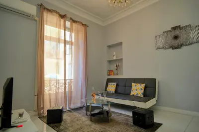 a living room with a couch and a glass table at Designer Flat Nice in Nice